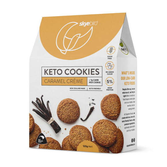 Picture shows box of keto caramel cookies with a number of keto caramel cookies on the front of the package with a Skyebird Foods company logo with a tan background on the front of the box of keto cookies. There's a prominent NZ made icon at the bottom of the keto cookie box to show the keto cookies are nz made. 